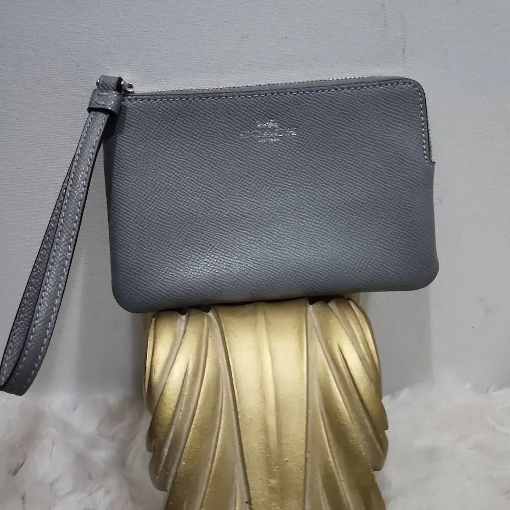 Coach Corner Zip Wristlet in a grey crossgrain leather.